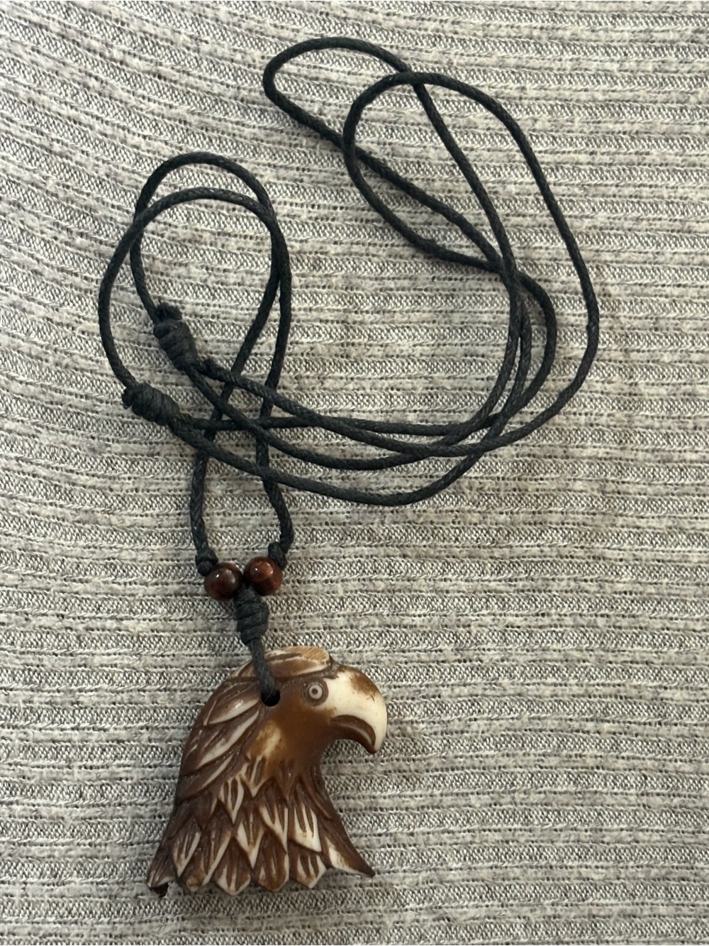 Brown & white eagle head pendant on black corded brown beaded necklace